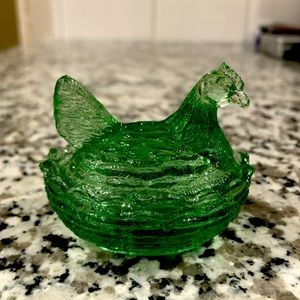 Vintage small green hen on a nest.